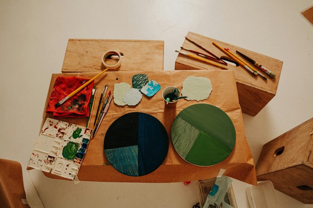 Choosing the Right Multi-Media Sketchbook Artistic arrangement of painting tools and palettes on wooden boxes for creative inspiration.